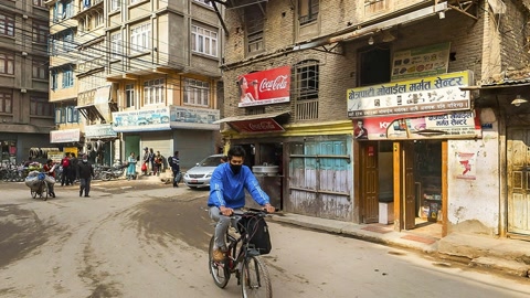 Urban street corner with shops and cyclists — Stillmotion