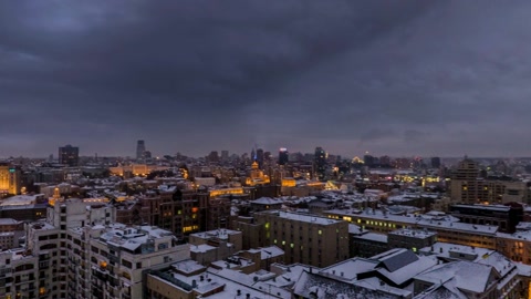 Snow-covered city at dusk — Stillmotion