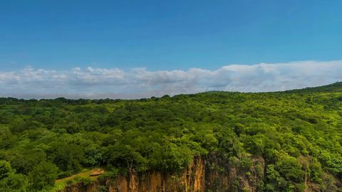 Tropical lagoon with forested cliffs — Stillmotion