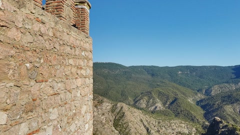 Paragliders above mountain fortress wall — Stillmotion
