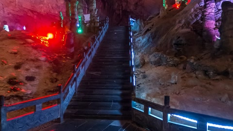 Lit cave chamber with walkway — Stillmotion