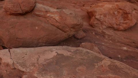 Red rock arch in desert canyon — Stillmotion
