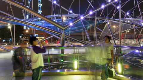 Lit bridge over city waterfront — Stillmotion