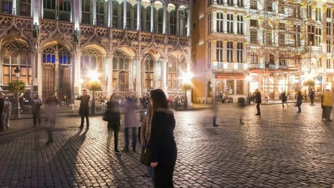 Lit cobblestone plaza at night — Stillmotion