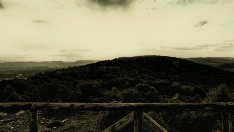 Windmill on cloudy hillside overlook — Stillmotion