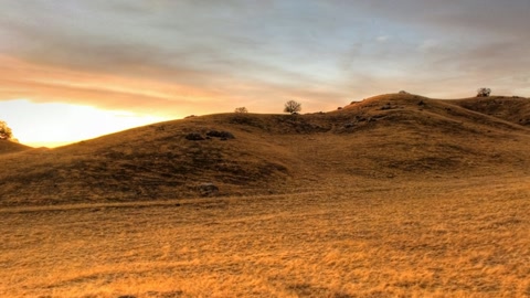 Sandy hills beside a road at sunset — Stillmotion
