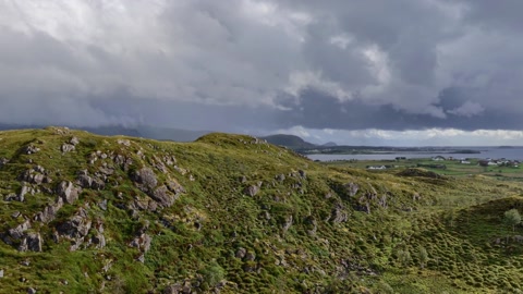 Cloudy tundra with rugged coastal hills — Stillmotion