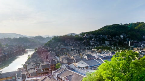 Riverside village among green hills — Stillmotion