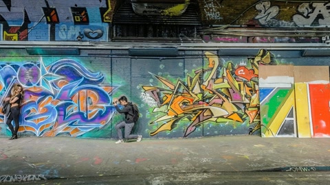 Graffiti-covered urban tunnel arcade — Stillmotion
