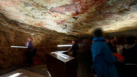 Illuminated grotto interior with visitors — Stillmotion