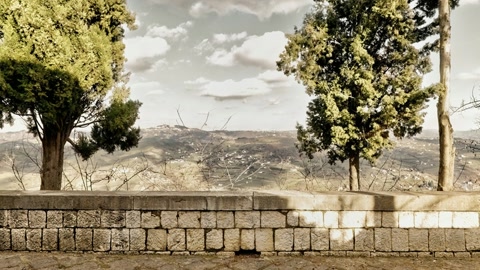 Mural-covered stone courtyard walkway — Stillmotion