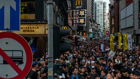 Crowded city plaza with signs — Stillmotion
