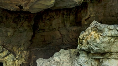 Rock grotto with waterfall and bridge — Stillmotion