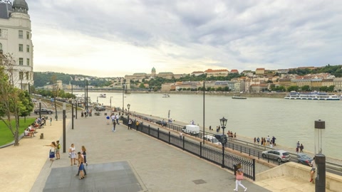 Riverside promenade with historic buildings — Stillmotion