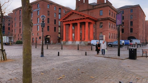 Waterfront promenade with brick buildings — Stillmotion