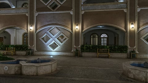 Illuminated courtyard with arched balconies — Stillmotion