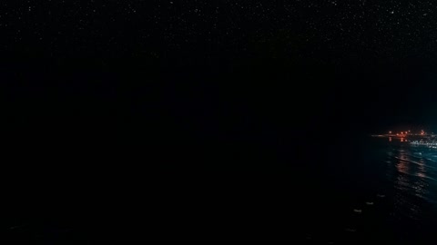 Coastal city lights at night — Stillmotion