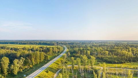 River channel beside forest and fields — Stillmotion