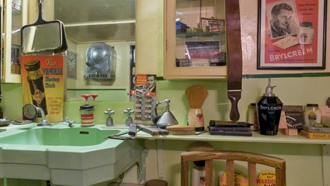 Vintage barber shop interior with sink and posters — Stillmotion