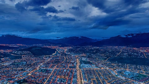 Aerial cityscape under cloudy skies — Stillmotion