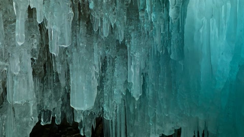Icy crevasse with hanging ice formations — Stillmotion