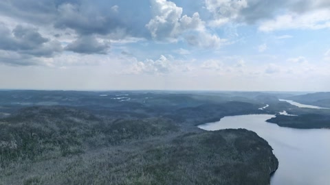 Aerial river valley with forested cliffs — Stillmotion