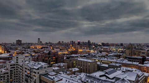 Snowy cityscape with illuminated streets — Stillmotion