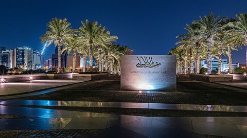 Night promenade by reflective pool — Stillmotion