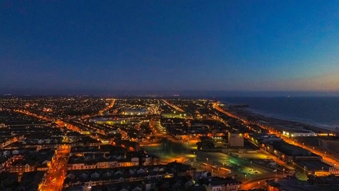 Aerial coastal city at dusk — Stillmotion