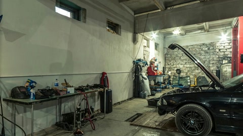 Car repair shop with lifted coupe — Stillmotion