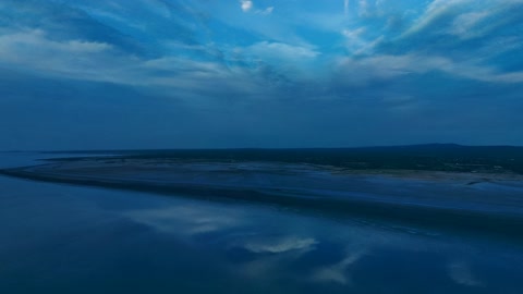 Cloudy sunset over calm water — Stillmotion