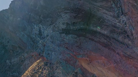 Rocky coastal cliffs over blue sea — Stillmotion