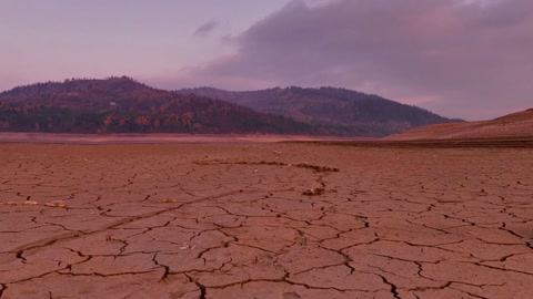 Cracked desert floor at sunset — Stillmotion