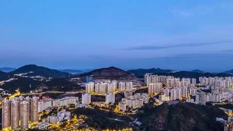 City lights over mountain harbor — Stillmotion