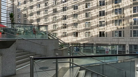 Glass atrium with walkways and planters — Stillmotion