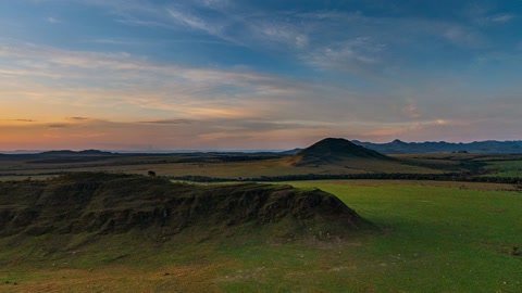 Sunset over green rocky plains — Stillmotion