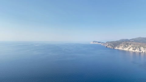 Coastal cliffs over calm sea — Stillmotion