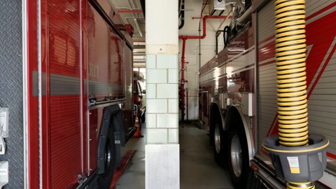 Fire station trucks inside bay — Stillmotion