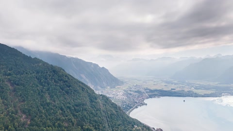 Mountain village overlooking a lake — Stillmotion