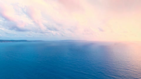 Cliff above calm sea at sunset — Stillmotion