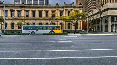 Urban street scene under cloudy skies — Stillmotion