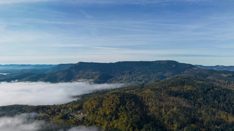 Aerial over foggy forested hills — Stillmotion