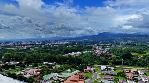 Hillside village under cloudy skies — Stillmotion