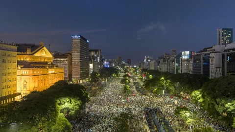 Crowded city square at night — Stillmotion