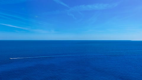 Rocky sea cliffs above turquoise water — Stillmotion