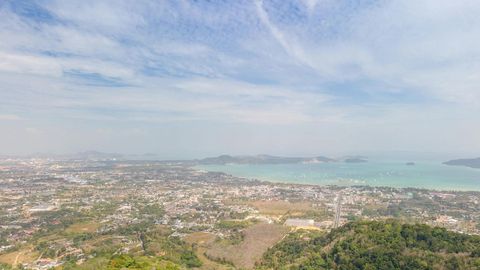 Green hills overlooking coastal city — Stillmotion