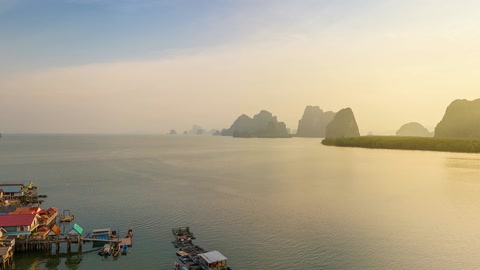 Sunlit islet above calm water — Stillmotion