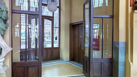 Historic interior hall with café seating — Stillmotion