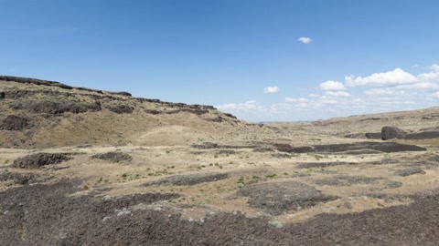 Badlands cliffside over water — Stillmotion