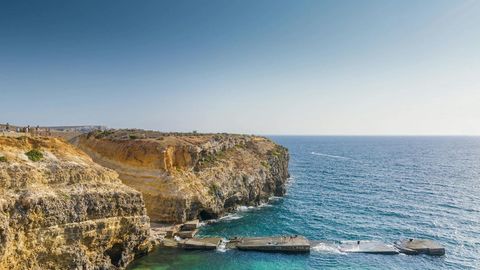 Coastal cliff and harbor village — Stillmotion